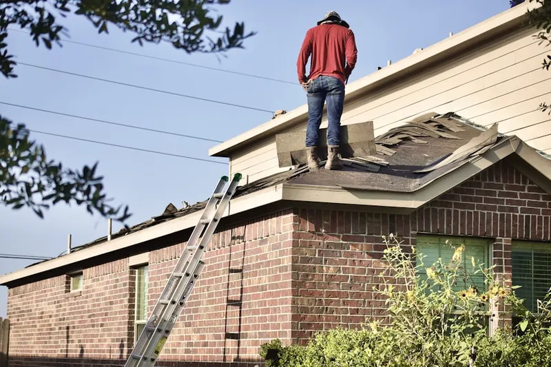 Professional roofer working on a residential roof in Benton Harbor